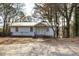 Charming home featuring a white exterior, a metal roof, and a simple entryway surrounded by mature trees at 251 Killian St, Canton, GA 30114