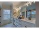 Spacious bathroom featuring a double vanity, modern lighting, and a walk-in shower at 220 Nicklaus Cir, Social Circle, GA 30025