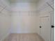 Spacious walk-in closet with wire shelving and neutral carpet at 220 Nicklaus Cir, Social Circle, GA 30025