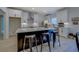 Stylish kitchen boasts a large island, modern stools, and white cabinets at 220 Nicklaus Cir, Social Circle, GA 30025