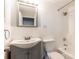 Compact bathroom with white tile, a gray vanity, and a shower-tub combination, offering a clean aesthetic at 300 W Peachtree St # 10D, Atlanta, GA 30308