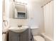 Cozy bathroom with white tile, a gray vanity, and a shower-tub combination, offering a clean aesthetic at 300 W Peachtree St # 10D, Atlanta, GA 30308
