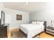 Cozy bedroom with hardwood floors, a gray upholstered bed, and soft, neutral tones at 300 W Peachtree St # 10D, Atlanta, GA 30308