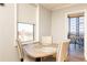 Cozy dining area with a round wooden table, comfortable chairs, and a balcony view at 300 W Peachtree St # 10D, Atlanta, GA 30308