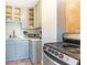 Functional kitchen with gray cabinets, tile backsplash, and modern appliances at 300 W Peachtree St # 10D, Atlanta, GA 30308