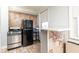 Compact kitchen featuring stone wall accent and stainless steel appliances, offering a practical design at 300 W Peachtree St # 10D, Atlanta, GA 30308