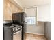 Bright kitchen featuring stainless steel oven and refrigerator with stone backsplash near window at 300 W Peachtree St # 10D, Atlanta, GA 30308