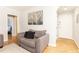 Cozy living room showcasing a modern design with wood floors and a comfortable gray chair at 300 W Peachtree St # 10D, Atlanta, GA 30308