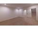 Basement area with wood plank flooring, door opening to the stairs to the main floor at 581 Sherwood Ne Rd, Atlanta, GA 30324