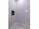 Modern bathroom with sleek white tile and a built in shower niche at 581 Sherwood Ne Rd, Atlanta, GA 30324