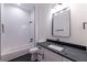 Modern bathroom featuring white subway tile, black finishes, and a sleek vanity with black countertop at 581 Sherwood Ne Rd, Atlanta, GA 30324