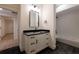 Bathroom features a white vanity with black countertop, tiled floor, and shower/tub combo at 581 Sherwood Ne Rd, Atlanta, GA 30324
