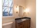 Bathroom featuring vanity with marble countertop and modern fixtures at 581 Sherwood Ne Rd, Atlanta, GA 30324