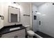 Modern bathroom with sleek vanity, black countertop and a glass-enclosed shower with white tile at 581 Sherwood Ne Rd, Atlanta, GA 30324