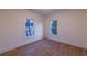 Bright bedroom with hardwood floors, two windows, and neutral walls at 581 Sherwood Ne Rd, Atlanta, GA 30324