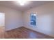 Bright bedroom with hardwood floors, a window with views, and neutral walls at 581 Sherwood Ne Rd, Atlanta, GA 30324