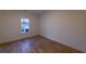 Cozy bedroom with hardwood floors, white trim, and a large window providing natural light at 581 Sherwood Ne Rd, Atlanta, GA 30324