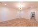 Spacious bedroom with wooden floors, chandelier, and doorway to the kitchen at 581 Sherwood Ne Rd, Atlanta, GA 30324