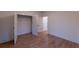 Neutral bedroom with hardwood floors, open closet, and white trim at 581 Sherwood Ne Rd, Atlanta, GA 30324