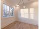 Bright bedroom featuring a large window and contemporary light fixture at 581 Sherwood Ne Rd, Atlanta, GA 30324