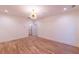 Bright bedroom boasting hardwood floors, a modern light fixture, and white trim at 581 Sherwood Ne Rd, Atlanta, GA 30324
