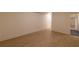 Hardwood floors and white walls in a bright hallway with doorway to a bathroom at 581 Sherwood Ne Rd, Atlanta, GA 30324