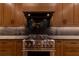 The gourmet kitchen features stainless steel appliances, a pot filler, and custom wood cabinetry at 581 Sherwood Ne Rd, Atlanta, GA 30324