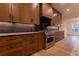 Custom kitchen with stainless steel oven, dark backsplash, and beautiful wood cabinets at 581 Sherwood Ne Rd, Atlanta, GA 30324