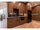 Custom kitchen featuring wood cabinets, a stainless steel microwave, and a black refrigerator at 581 Sherwood Ne Rd, Atlanta, GA 30324