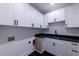 The laundry room includes white cabinets and black countertops at 581 Sherwood Ne Rd, Atlanta, GA 30324