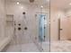 Spacious glass shower with dual shower heads, built-in bench, and modern tile surround at 581 Sherwood Ne Rd, Atlanta, GA 30324