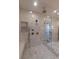 Spacious glass shower with dual shower heads, tile surround, built-in bench, and gold fixtures at 581 Sherwood Ne Rd, Atlanta, GA 30324