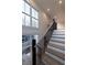 Bright stairway with wood steps, black iron railing, and large windows providing natural light at 581 Sherwood Ne Rd, Atlanta, GA 30324