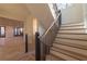 Staircase with wood treads, black iron railings, and an open floor plan at 581 Sherwood Ne Rd, Atlanta, GA 30324