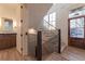 Staircase with wood steps, black railings, a bathroom, and a wood front door at 581 Sherwood Ne Rd, Atlanta, GA 30324