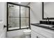 Bathroom featuring a tiled shower with glass doors and modern fixtures at 202 Via Lucca, Woodstock, GA 30188