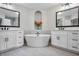 Luxurious bathroom showcasing a soaking tub, dual vanities, and modern fixtures at 202 Via Lucca, Woodstock, GA 30188