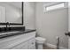 Bathroom vanity with black countertop and fixtures, offering a contemporary design at 202 Via Lucca, Woodstock, GA 30188