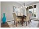 Dining area with modern chandelier and view to a large window at 202 Via Lucca, Woodstock, GA 30188