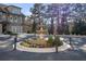 Decorative water fountain with manicured plants outside of a stone home at 202 Via Lucca, Woodstock, GA 30188