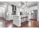 Bright kitchen features hardwood floors, white cabinets, stainless appliances, and pendant lights at 202 Via Lucca, Woodstock, GA 30188