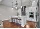 Modern kitchen with white cabinetry, stainless steel appliances, and pendant lighting at 202 Via Lucca, Woodstock, GA 30188