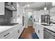 Stylish kitchen with white cabinets, stainless steel appliances, subway tile, and island at 202 Via Lucca, Woodstock, GA 30188