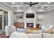 Inviting living room with coffered ceilings, fireplace, hardwood floors, and outdoor access at 202 Via Lucca, Woodstock, GA 30188