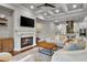 Open living room with coffered ceiling, fireplace, hardwood floors, flows into the kitchen at 202 Via Lucca, Woodstock, GA 30188