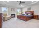 Spacious main bedroom with a fireplace, tray ceiling, and plenty of natural light at 202 Via Lucca, Woodstock, GA 30188