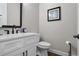 Modern powder room with white vanity, black hardware, and elegant fixtures at 202 Via Lucca, Woodstock, GA 30188