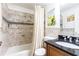 Bathroom with a shower-tub combo, granite countertop and modern fixtures at 300 W Peachtree St # 4A, Atlanta, GA 30308