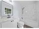 Well-lit bathroom with a marble countertop, updated fixtures, and modern tile at 463 Flint Trl, Jonesboro, GA 30236
