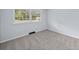 This bedroom offers plush carpeting and a bright window for a cozy retreat at 463 Flint Trl, Jonesboro, GA 30236